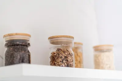 three glass jars filled with seeds on a shelf at Emirates White Sensation in Sofia