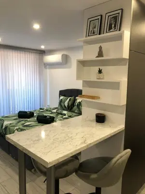 a room with a table and a bed in a room at Ultra Lux Studio Free Underground Secure Parking in Pazardzhik