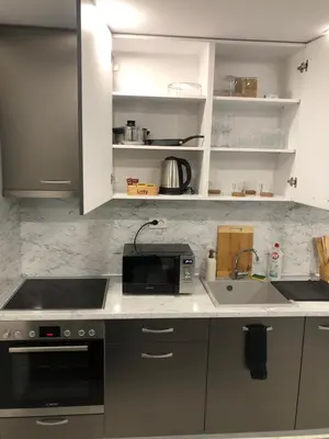 a kitchen with a sink and a stove top oven at Ultra Lux Studio Free Underground Secure Parking in Pazardzhik