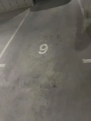 a number painted on the floor of a parking lot at Ultra Lux Studio Free Underground Secure Parking in Pazardzhik