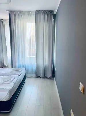 a small bedroom with a bed and a window at Magenta Apartment with free WiFi in Sofia