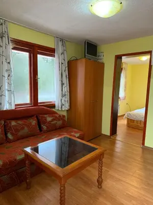 a living room with a couch and a coffee table at Вила за гости “Попина лъка” in Vikhren