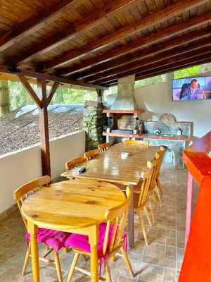 a large wooden table and chairs in a kitchen at Вила за гости “Попина лъка” in Vikhren