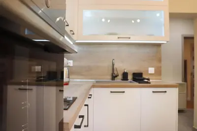 a kitchen with white cabinets and a sink at Stylish and Quiet Apt with Balcony in Sofia