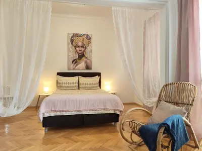 a bedroom with a bed and a painting on the wall at Sofia Center Chic Suite - Separate Kitchen and Balcony in Sofia