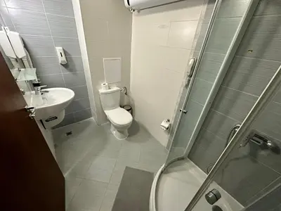 a bathroom with a toilet and a sink and a shower at Nice apartment in Belvedere Club in Bansko