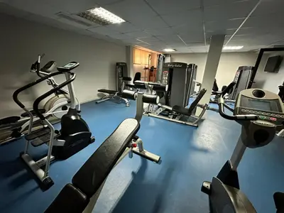 a gym with several treadmills and cardio machines at Nice apartment in Belvedere Club in Bansko
