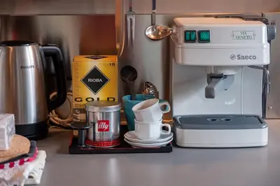 a kitchen counter with a coffee maker and a mixer at The Gallery - Art Studio in the Heart of Sofia by Flat Mаnager in Sofia