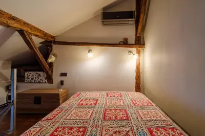 a bedroom with a bed in a attic at The Gallery - Art Studio in the Heart of Sofia by Flat Mаnager in Sofia