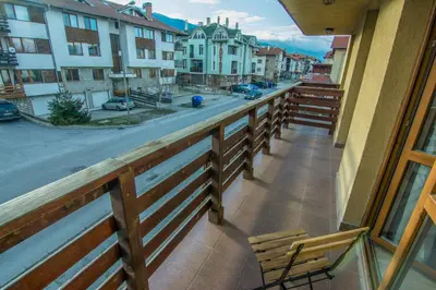 a balcony with a bench and a view of a street at Banderitsa Apartment 1 in Bansko