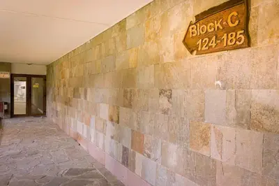 a building with a brick wall with a sign on it at Mountain Apartment in Borovets Ski Resort in Borovets