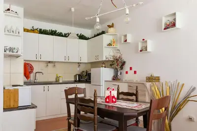 a kitchen with a table and chairs in a room at Mountain Apartment in Borovets Ski Resort in Borovets
