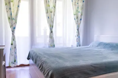 a bedroom with a bed and a window with curtains at Mountain Apartment in Borovets Ski Resort in Borovets