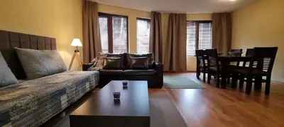 a living room with a couch and a table at Private Suite at Comfort Bansko in Bansko