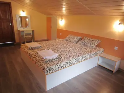 a bedroom with a large bed in a room at Slavina Guest House in Sapareva Banya