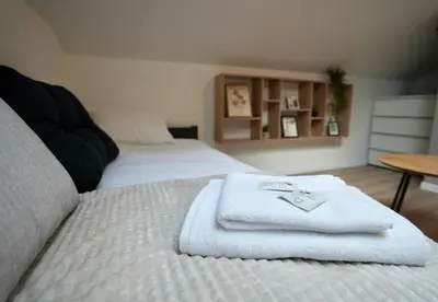 a room with two beds with white towels on them at Lily's Studio 3 by Bulgarentals - Central Sofia in Sofia