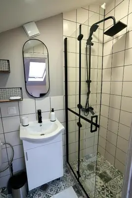 a bathroom with a sink and a shower at Lily's Studio 3 by Bulgarentals - Central Sofia in Sofia