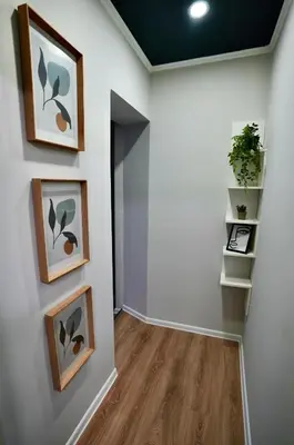a hallway with paintings on the wall and a shelf at Lily's Studio 3 by Bulgarentals - Central Sofia in Sofia