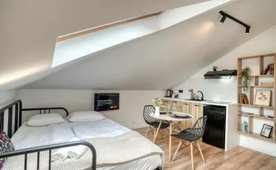 a bedroom with a bed and a table and chairs at Lily's Studio 1 by Bulgarentals - Central Sofia in Sofia