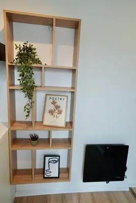 a book shelf in a living room with a tv at Lily's Studio 1 by Bulgarentals - Central Sofia in Sofia