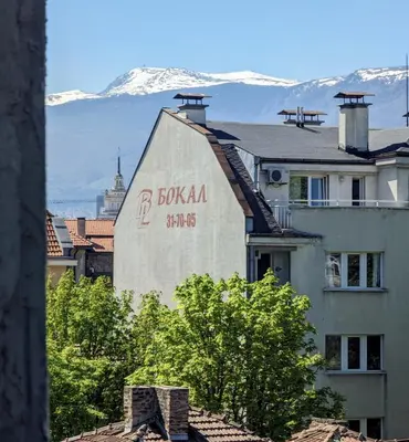 a building with a sign on the side of it at Lily's Studio 1 by Bulgarentals - Central Sofia in Sofia
