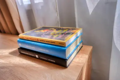 a stack of books sitting on a shelf at Lily's Studio 4 by Bulgarentals - Central Sofia in Sofia