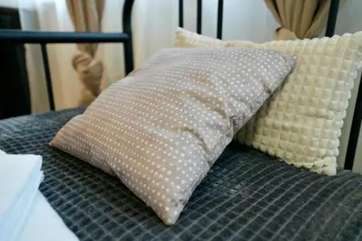 a pillow sitting on top of a bed at Lily's Studio 4 by Bulgarentals - Central Sofia in Sofia