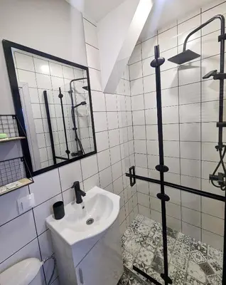 a white bathroom with a sink and a mirror at Lily's Studio 5 by Bulgarentals - Central Sofia in Sofia