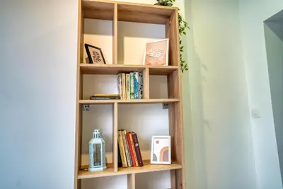 a book shelf with books and other items on it at Lily's Studio 6 by Bulgarentals - Central Sofia in Sofia