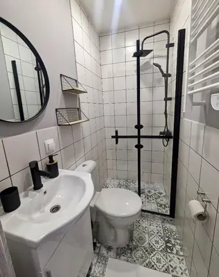 a white bathroom with a sink and a toilet at Lily's Studio 6 by Bulgarentals - Central Sofia in Sofia