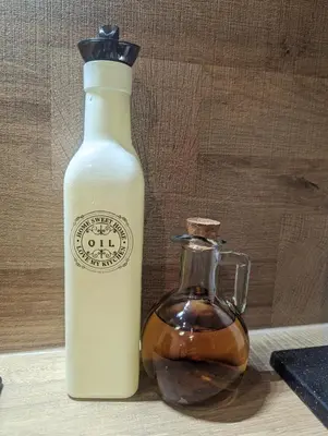 a bottle of oil next to a glass jar at Lily's Studio 7 by Bulgarentals - Central Sofia in Sofia