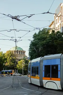 a tram on a city street with a building at Lily's Studio 7 by Bulgarentals - Central Sofia in Sofia