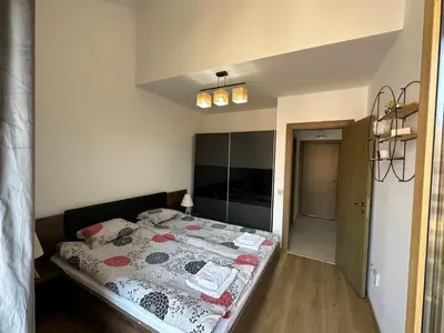 a bedroom with a bed in a room at Cozy duplex apartment in St. John Park in Bansko
