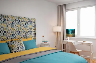 a bedroom with a bed and a desk and a window at Bright and Stylish 2BD Flat in The City Centre by Flat Mаnager in Sofia