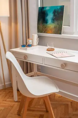 a white desk with a white chair and a painting at Bright and Stylish 2BD Flat in The City Centre by Flat Mаnager in Sofia