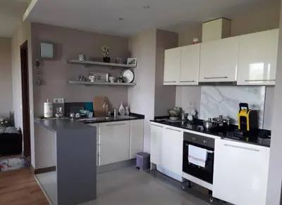 a kitchen with white cabinets and a stove at Apartament by Zenit in Terra Complex B30 in Razlog