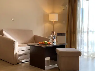 a living room with a couch and a table with fruit on it at Banderitsa Studio Bansko 2 in Bansko