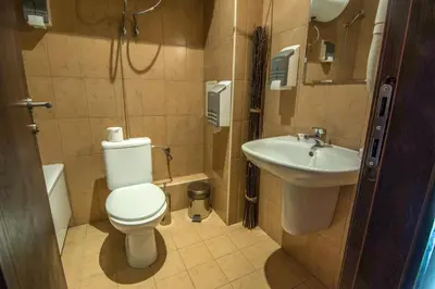 a small bathroom with a toilet and a sink at Banderitsa Studio Bansko 2 in Bansko