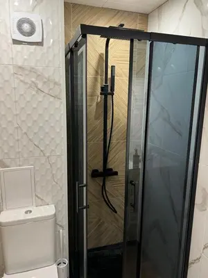 a glass shower in a bathroom with a toilet at Avelov Art Studio in Pamporovo