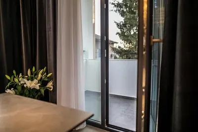 a room with a window with a vase of flowers at ARHEYA 1 apart Архея 1 апартамент за гости in Karlovo