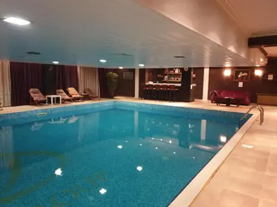 a large swimming pool in a hotel room at апартаменти Уют Гранд Манастира in Pamporovo