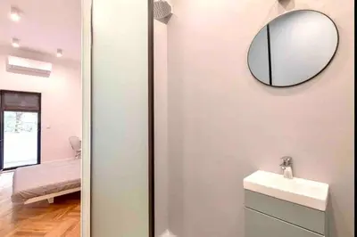 a bathroom with a sink and a mirror on the wall at Heart of the city in Sofia