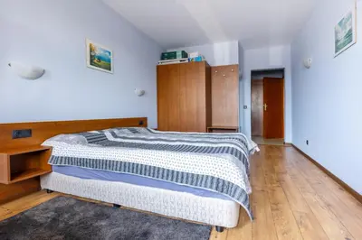 a bedroom with a bed with a blue and white comforter at One bedroom apartment in Hotel Banderitsa ,Bansko in Bansko