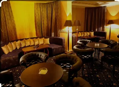 a hotel room with a couch and chairs and tables at Snow Mountain Grand Monastery in Pamporovo