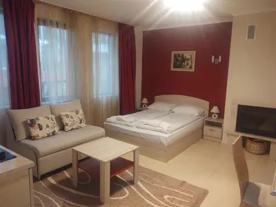 a living room with a bed and a couch at Snow Mountain Grand Monastery in Pamporovo