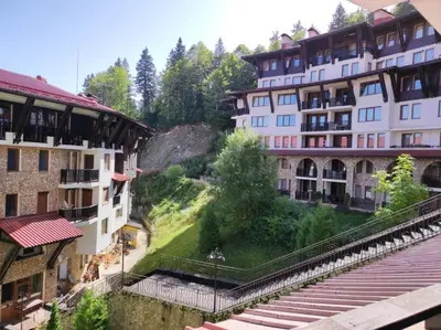 a view of two buildings and a train station at Snowy tale in Pamporovo