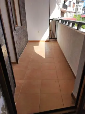 a hallway with a tile floor in a building at Snowy tale in Pamporovo