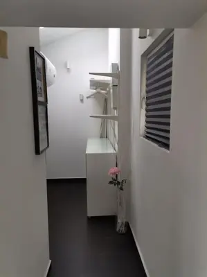 a hallway with white walls and a black floor at Sky-view apartmentin perfect city center Sofia in Sofia