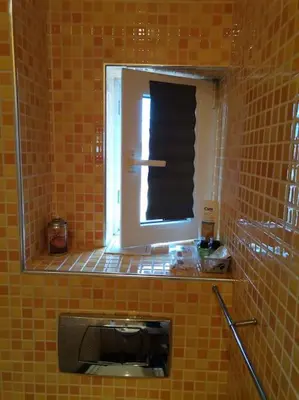 a mirror in a tiled bathroom with a sink at Sky-view apartmentin perfect city center Sofia in Sofia