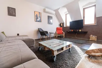 a living room with a couch and a coffee table at Penthouse Tepeto in Plovdiv